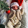 baby, sleeping, santa_hat, christmas, holiday, ornament, pine_branch, blanket, cozy, infant, clothing, vest, pajamas, festive, holiday_decor, cute, soft, peaceful, portrait, indoor