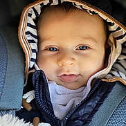 Elio participe au concours pour gagner de l'argent avec cette photo : baby, child, hood, jacket, blanket, blue_eyes, face, infant, cute, warm, clothing, portrait, closeup, baby_carrier, soft, smile, snuggled, striped, young, cozy