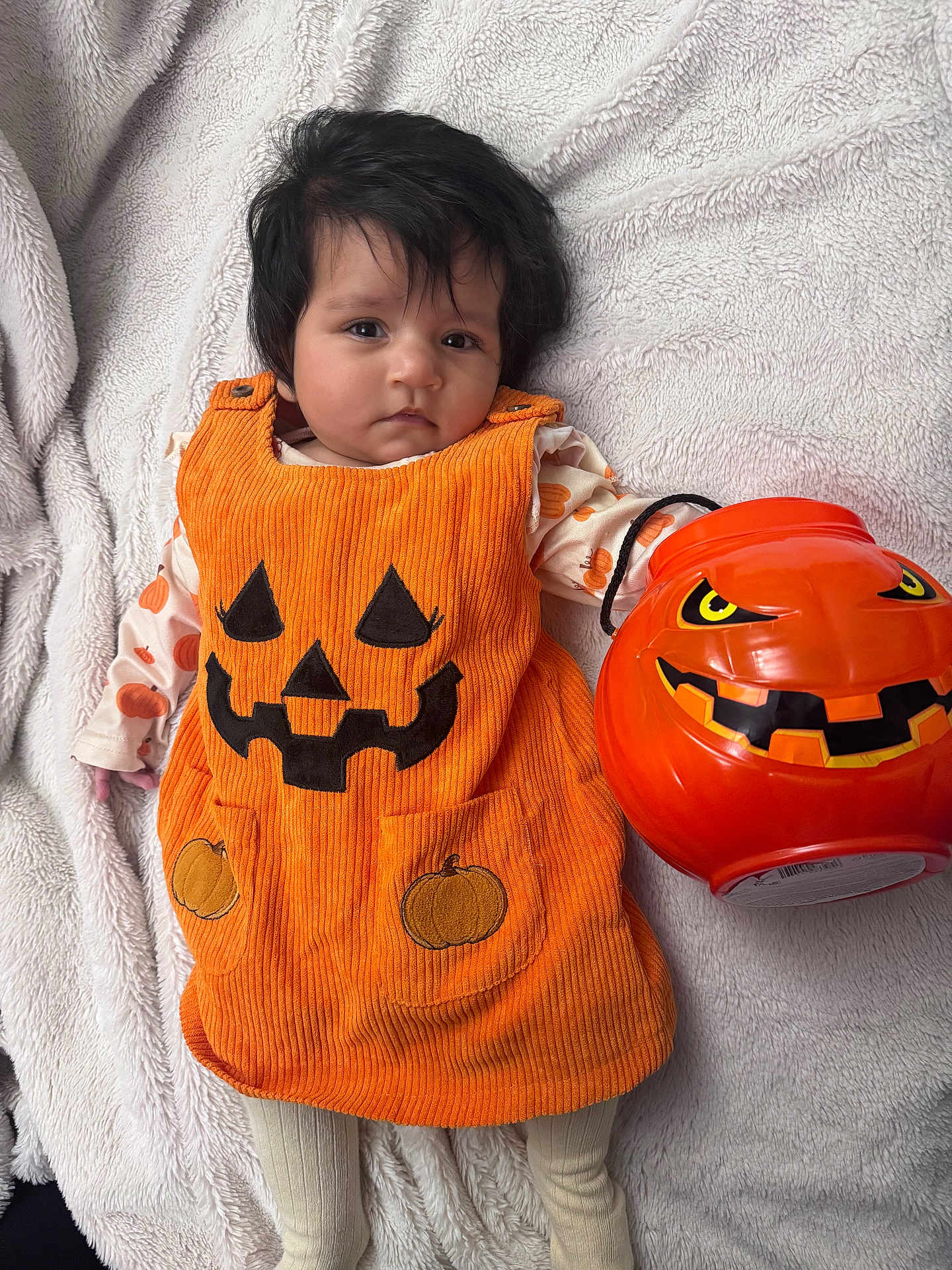 Siya joined the competition — help win amazing prizes! baby, blanket, bucket, child, clothing, costume, cute, face, festive, halloween, holiday, indoor, infant, lying_down, orange, person, plastic, pumpkin, smile, toy