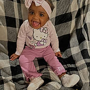Amillion joined the competition — help win amazing prizes! baby, child, smiling, pink_clothing, headband, bow, hello_kitty, sitting, blanket, checkered_pattern, shoes, happy, indoors, cute, portrait, young_child, infant, cozy, clothing, person