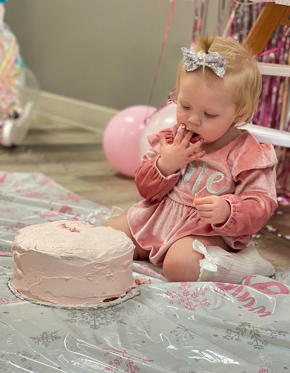 Lillian is registered to the contest to win money with this photo: baby, baby_toddler_clothing, baked_goods, birthday_cake, birthday_party, buttercream, cake, cake_decorating, cake_decorating_supply, child, dessert, dress, event, food, person, pink, shelf, sugar_cake, sugar_paste, tableware