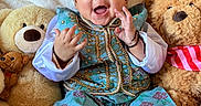 Nayan is registered to the contest to win money with this photo: baby, child, teddy_bear, plush_toy, blue_outfit, hat, smiling, sitting, clapping, cute, soft_blanket, indoors, portrait, happy, infant, white_socks, decorative_clothing, toy, close_up, face