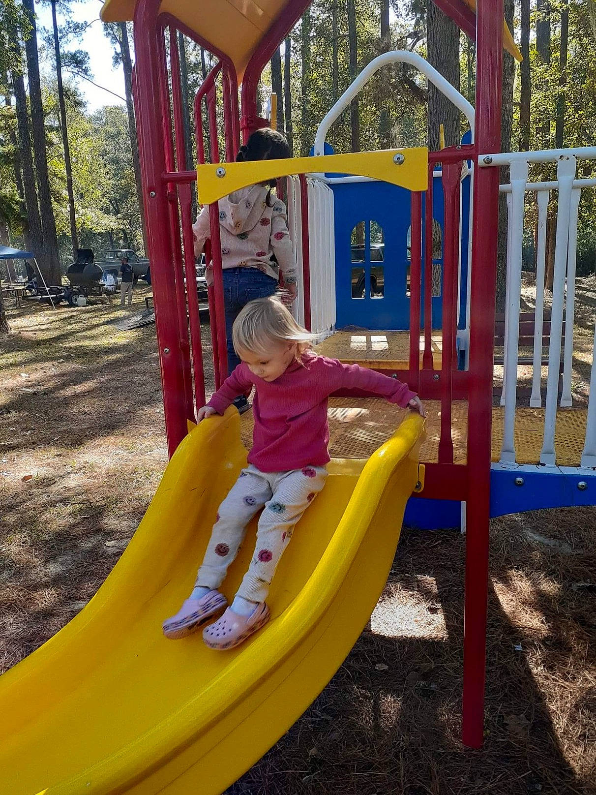Brilynn is registered to the contest to win money with this photo: baby_toddler_clothing, child, chute, city, fun, grass, leisure, outdoor_play_equipment, outdoor_recreation, person, plant, play, playground, playground_slide, recreation, toddler, tree, yellow