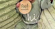 Hyacinth joined the competition — help win amazing prizes! baby, blanket, child, couch, cozy, cute, expression, fabric, feet, green_clothing, hand, headband, indoors, infant, newborn, person, portrait, sitting, soft_texture, wooden_sign