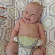 Ridian is registered to the contest to win money with this photo: baby, infant, smiling, sitting, seat, patterned, indoor, child, cute, happy, skin, bare_chest, legs, feet, hands, diaper, comfort, joy, young, childcare