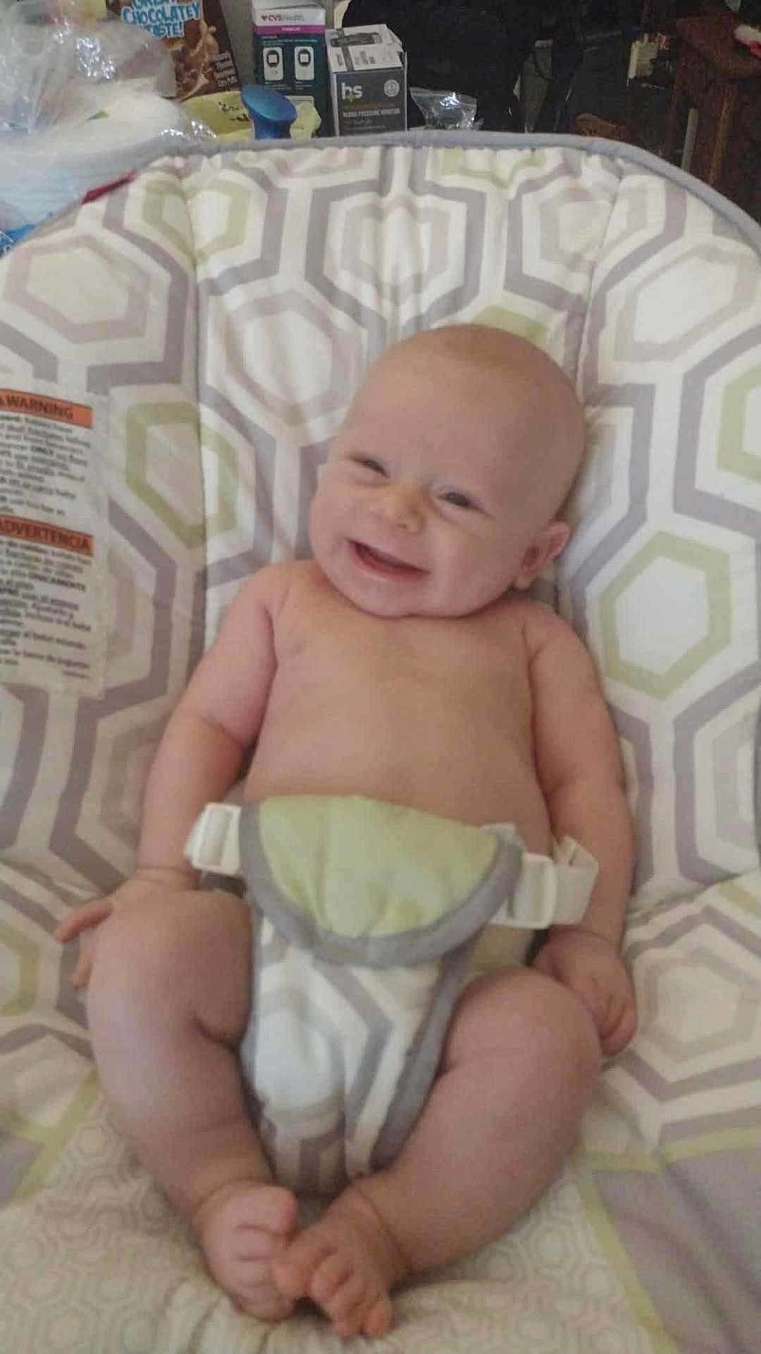 Ridian is registered to the contest to win money with this photo: baby, infant, smiling, sitting, seat, patterned, indoor, child, cute, happy, skin, bare_chest, legs, feet, hands, diaper, comfort, joy, young, childcare