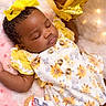 baby, sleeping, yellow_bow, sunflower_dress, pink_blanket, gold_balloon, first_birthday, infant, cute, celebration, soft_lighting, fairy_lights, child, portrait, adorable, festive, holiday, happy, resting, small_person