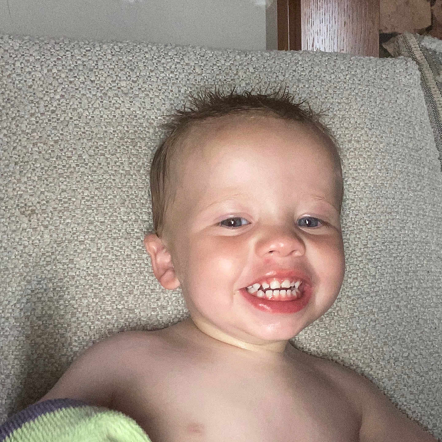 Jayden-James joined the competition — help win amazing prizes! bare_chest, child, closeup, couch, face, furniture, happy, indoor, person, portrait, relaxing, smile, stone, teeth, texture, toddler, towel, wet_hair, wood, young_child