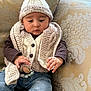 Zohaan is registered to the contest to win money with this photo: baby, beanie, bodypart, bonnet, cap, clothing, couch, face, finger, furniture, hand, hat, head, jeans, knitwear, pants, person, photography, portrait, sweater