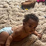 baby, diaper, carpet, toy, blanket, curly_hair, child, indoor, floor, playtime, infant, soft_texture, crawling, cute, person, home, relaxed, looking_up, skin, hand