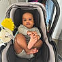 Ysmaël participe au concours pour gagner de l'argent avec cette photo : baby, stroller, infant, child, toy, yellow_flower, foot, grabbing, gray, clothing, jeans, sneakers, indoor, floor, person, hand, face, curious, expression, seat