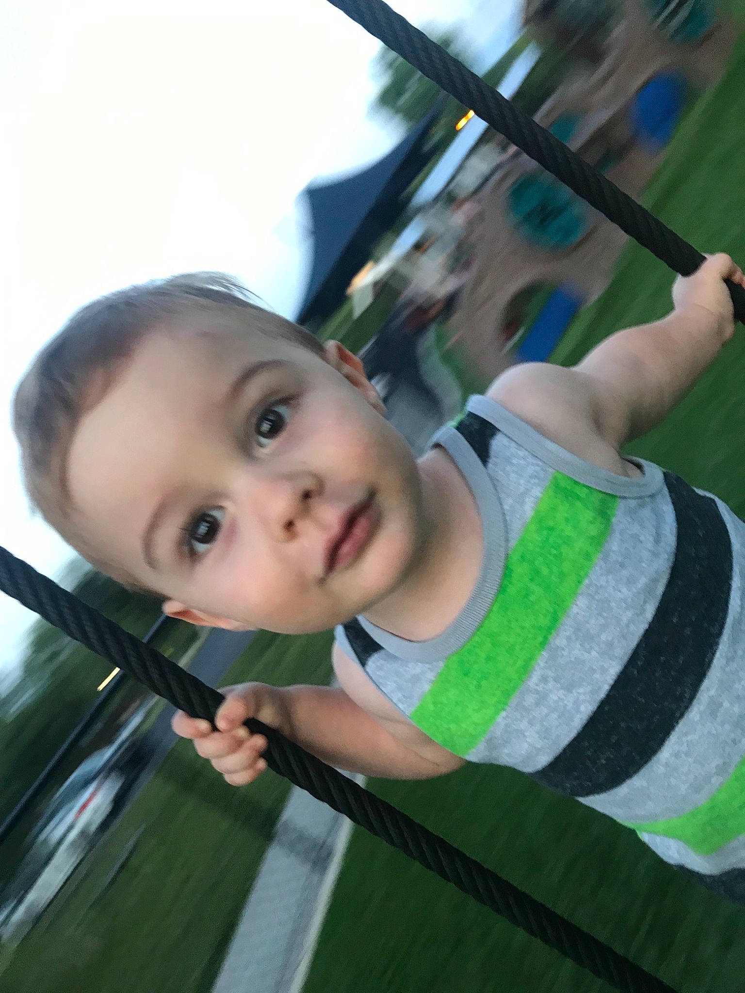 Greyson is registered to the contest to win money with this photo: baby, child, eye, face, grass, green, leisure, person, plant, playground, skin, smile, swing, toddler, tree