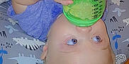 Theodore is registered to the contest to win money with this photo: baby, child, blue_eyes, sippy_cup, pillow, blanket, lying_down, infant, hand, face, curious, indoor, soft_toys, baby_essentials, bottle, clothing, skin, head, young_child, cute