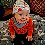 Theodore joined the competition — help win amazing prizes! baby, child, smiling, hat, orange_shirt, pumpkin, halloween, cushion, dinosaur_pattern, indoors, happy, cute, toddler, clothing, face, hands, seated, headwear, portrait, expression