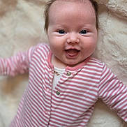 Thea joined the competition — help win amazing prizes! baby, infant, smile, happy, onesie, striped_clothing, pink, white, face, portrait, lying_down, soft_blanket, cute, child, young, closeup, human, skin, head, eyes