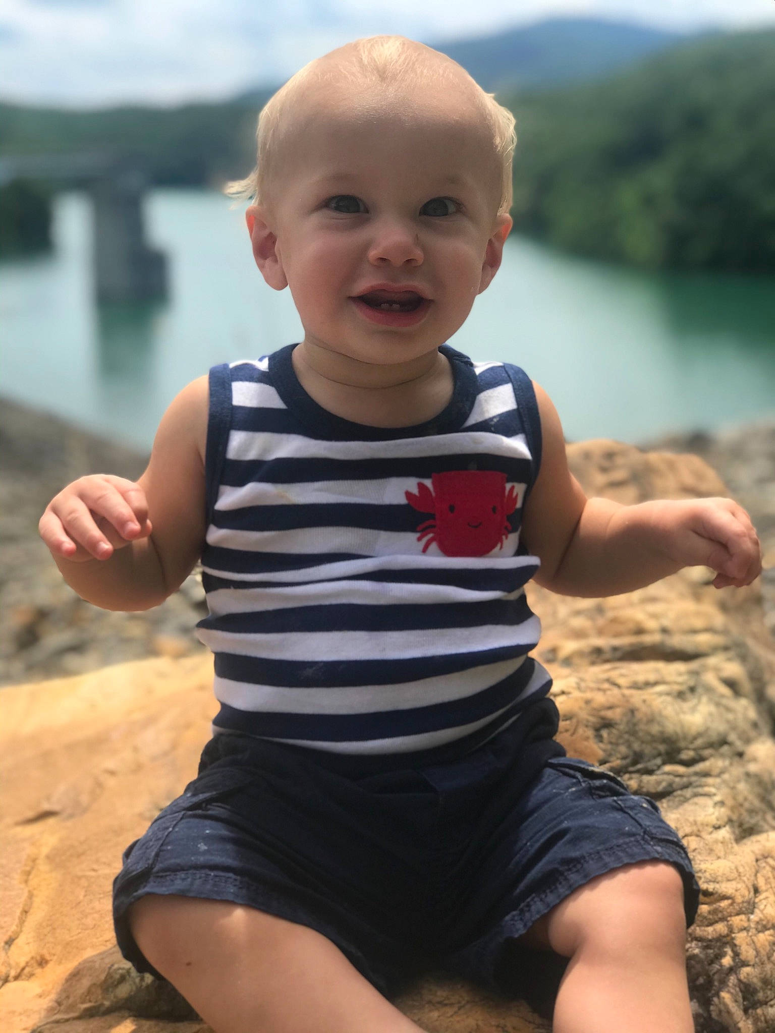 Ashtyn is registered to the contest to win money with this photo: child, finger, fun, happy, leg, leisure, person, play, sitting, smile, summer, t_shirt, thumb, toddler, vacation, water