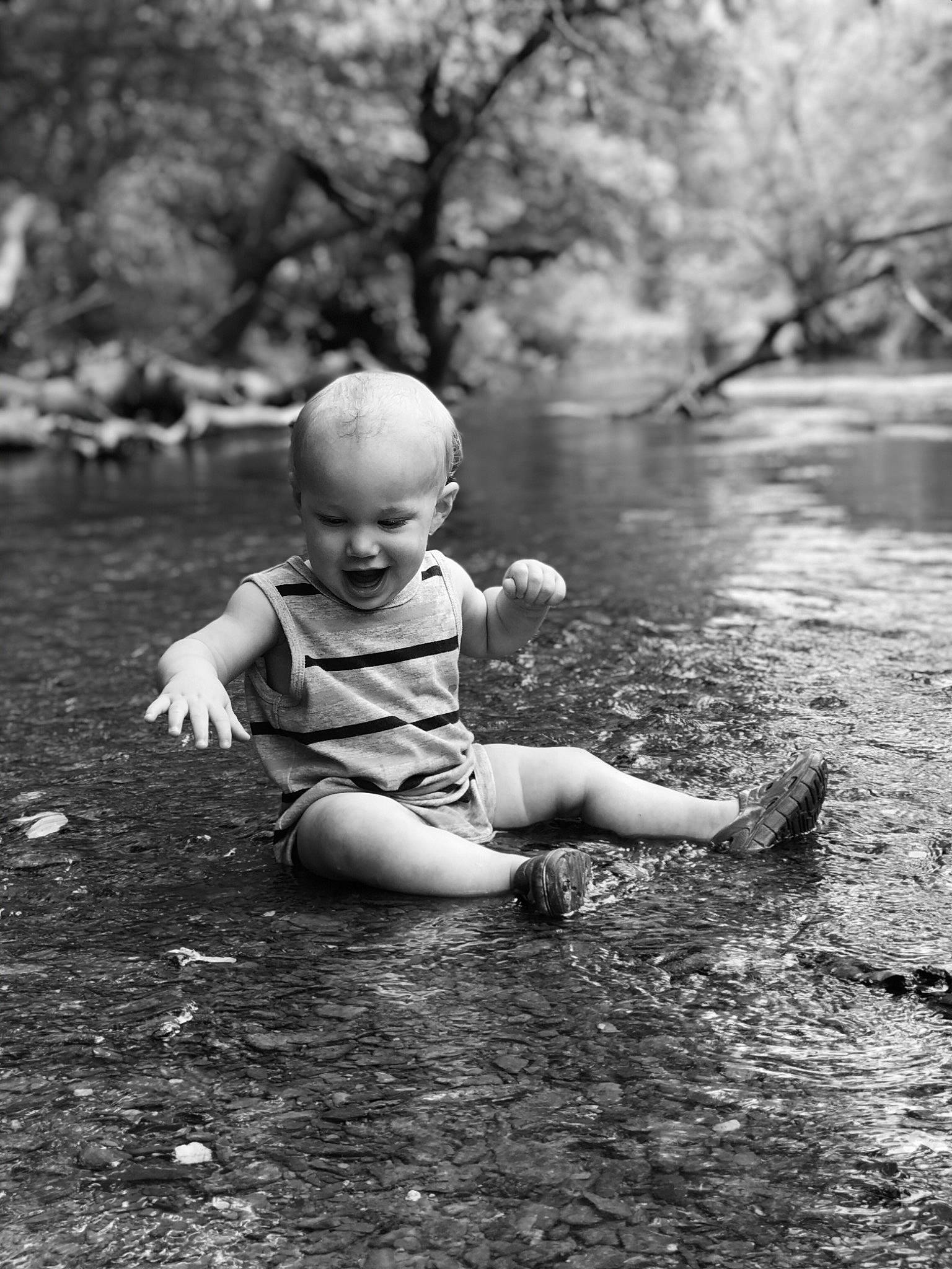 Ashtyn joined the competition — help win amazing prizes! baby, bank, black_and_white, child, fun, monochrome, monochrome_photography, person, photograph, photography, plant, play, portrait, river, rock, sitting, stock_photography, stream, toddler, tree