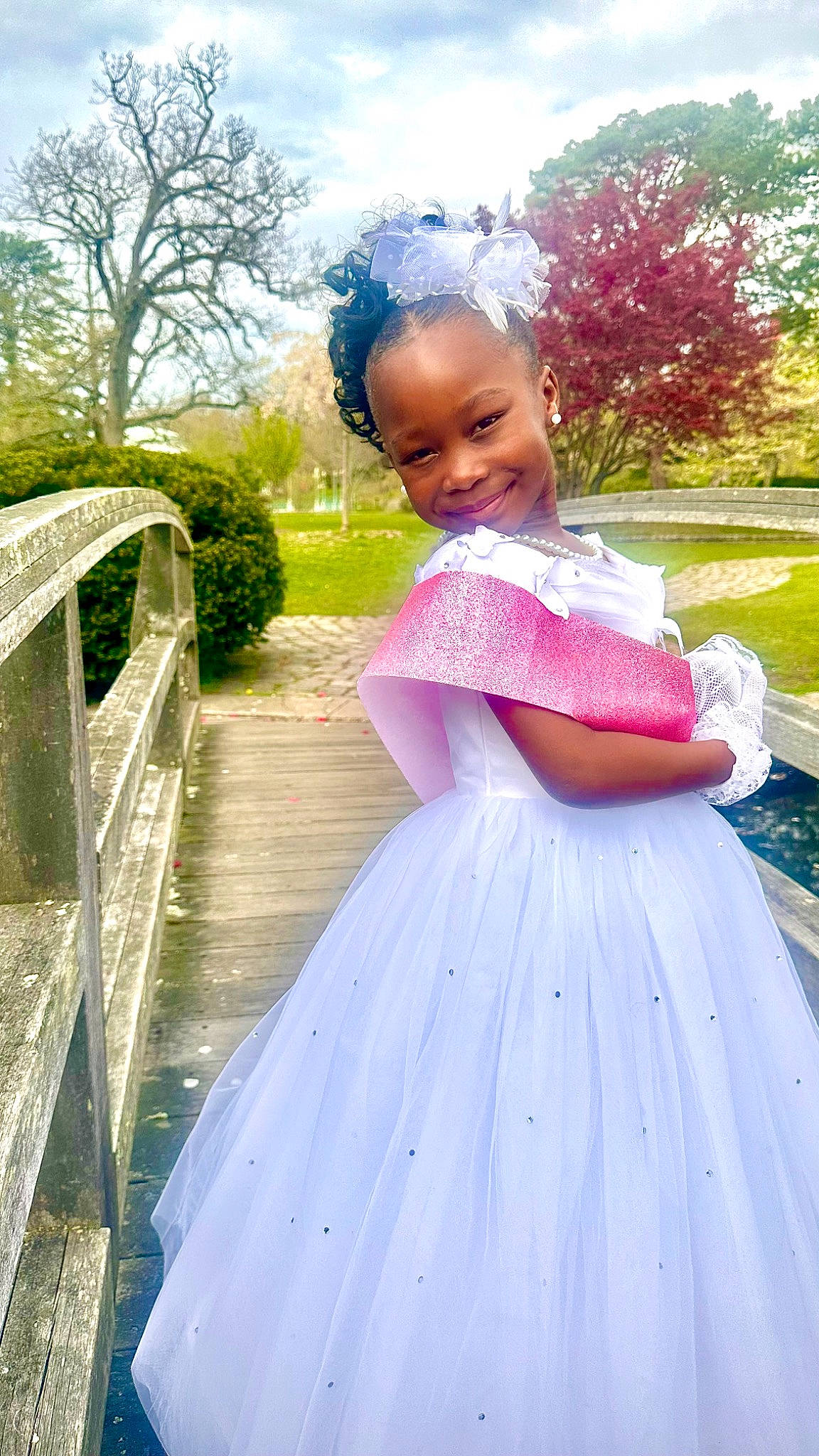 Michelle joined the competition — help win amazing prizes! botany, bridal_clothing, bridal_party_dress, dress, embellishment, facial_expression, formal_wear, gown, grass, happy, joy, magenta, outerwear, person, pink, plant, shoulder, sky, smile, standing