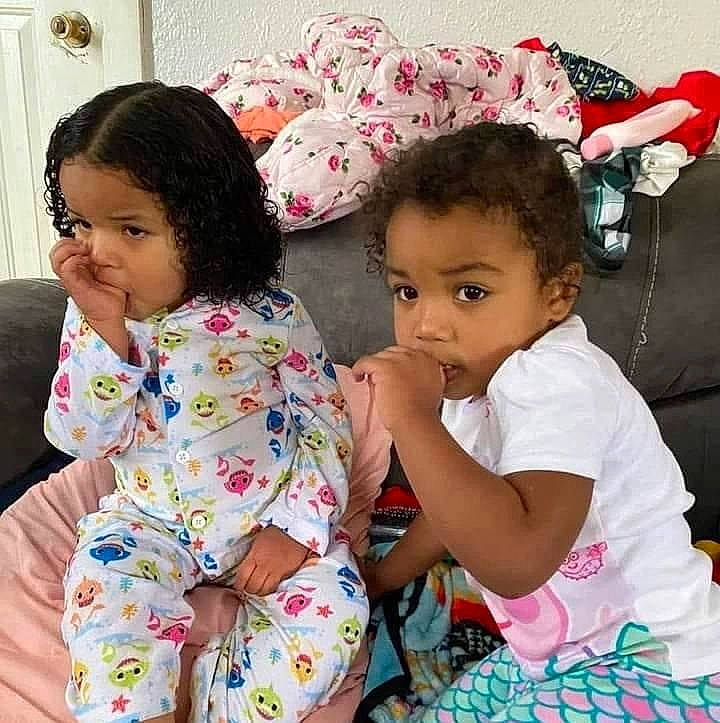 Sylvia is registered to the contest to win money with this photo: arm, baby_toddler_clothing, cheek, child, eye, face, hair, hairstyle, hand, happy, head, interaction, iris, nose, person, pink, sharing, skin, sleeve, toddler