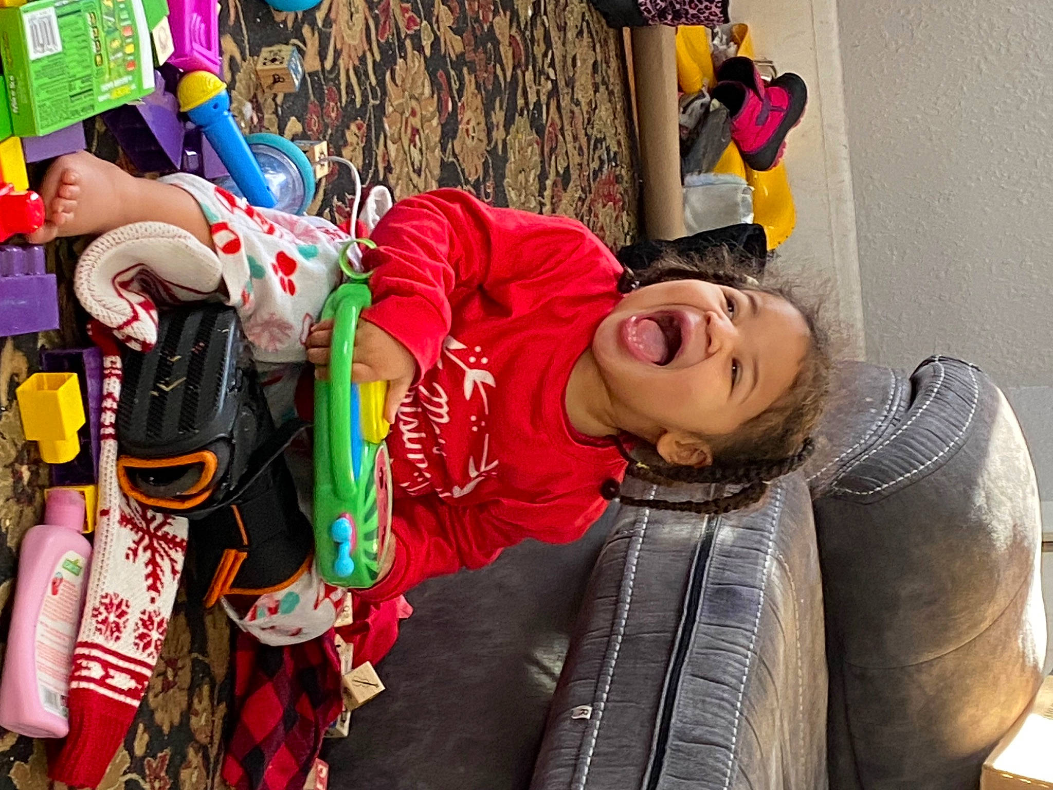 Olivia is registered to the contest to win money with this photo: bag, child, costume, event, fictional_character, fun, happy, hat, leisure, luggage_and_bags, person, room, sitting, smile, street, temple, textile, toddler, tradition, tree