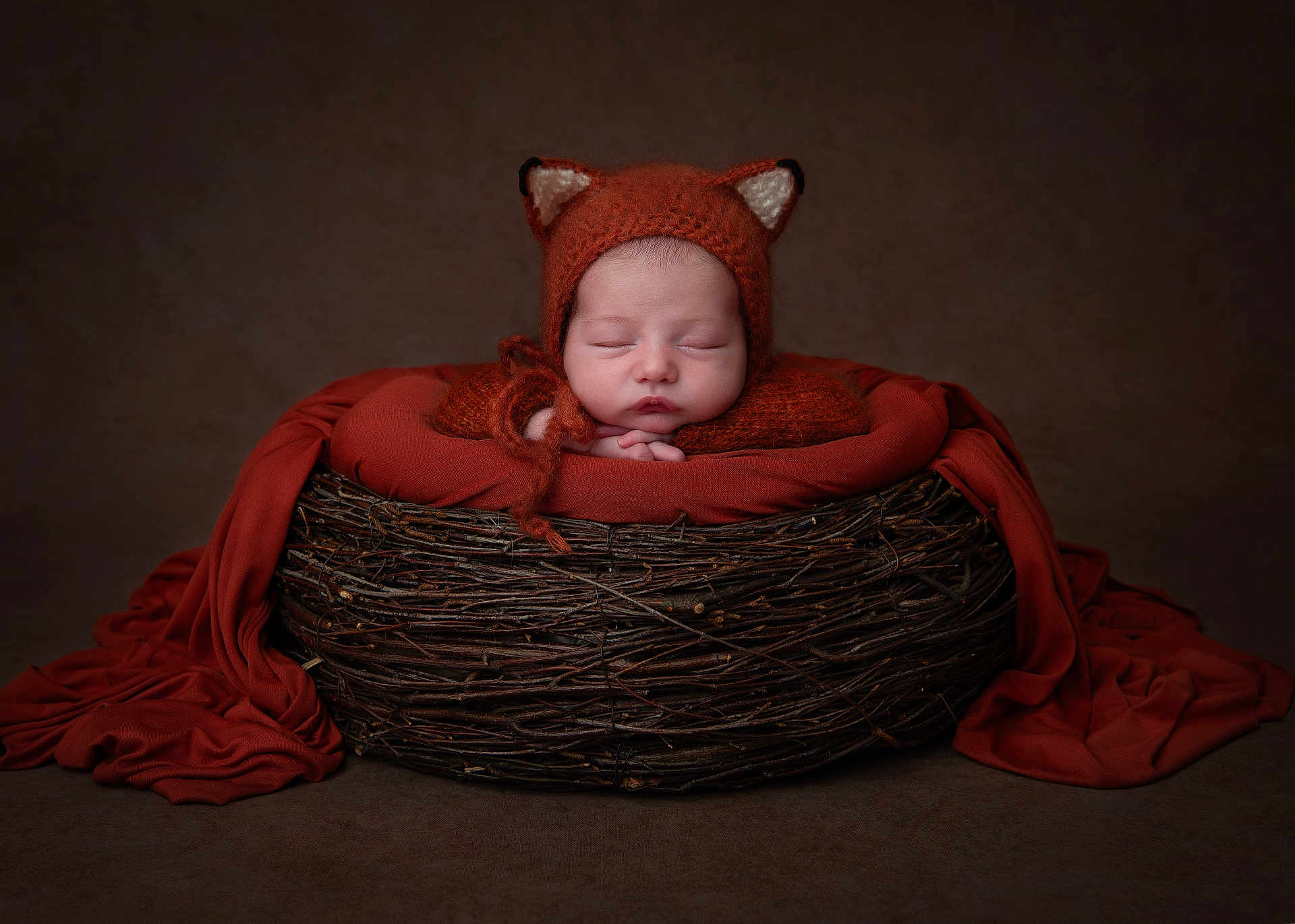 Eddie joined the competition — help win amazing prizes! newborn, baby, sleeping, fox_hat, knitwear, basket, twigs, orange_cloth, portrait, cozy, cute, infant, resting, studio, soft_lighting, props, child, headwear, peaceful, wrapped