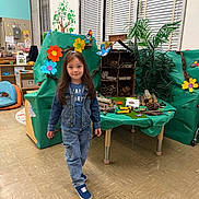 Sadiya joined the competition — help win amazing prizes! child, girl, denim_jacket, jeans, sneakers, classroom, craft, paper_flowers, insect_hotel, nature_theme, educational, table, green_paper, plants, wood, floor, window_blinds, smiling, long_hair, indoor