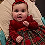 Aleksandra is registered to the contest to win money with this photo: baby, baby_seat, background, bow, cheerful, child, clothing, cushion, cute, festive, happy, headband, holiday, indoor, infant, person, plaid, portrait, red_dress, smiling