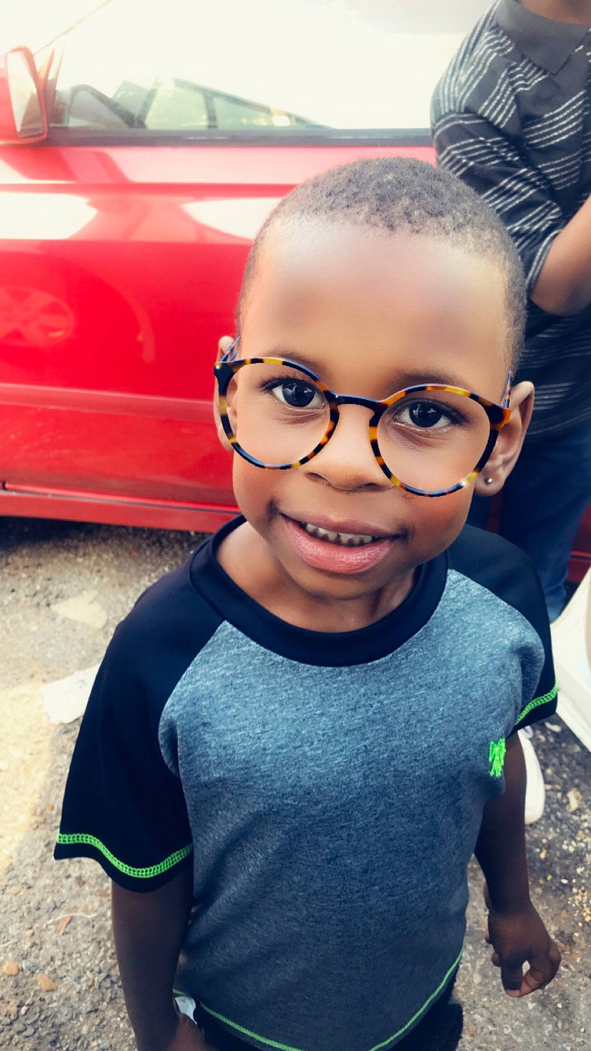 Larry Jr joined the competition — help win amazing prizes! asphalt, automotive_tire, car, chin, cool, electric_blue, eye, eyebrow, eyewear, facial_expression, glasses, hairstyle, happy, joy, mouth, nose, person, smile, t_shirt, toddler