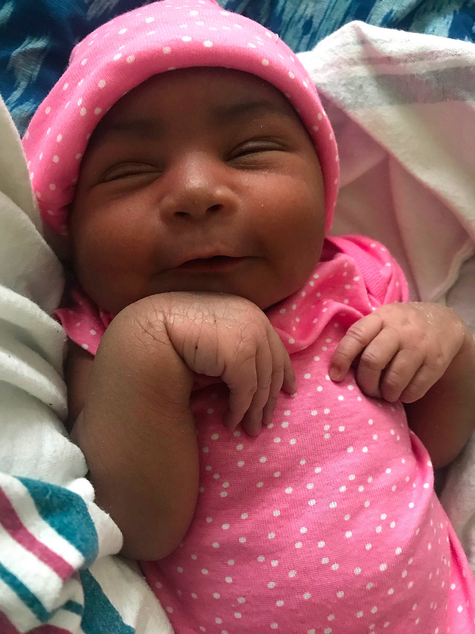 Denise is registered to the contest to win money with this photo: baby, baby_toddler_clothing, cheek, chin, comfort, facial_expression, finger, fun, gesture, happy, headwear, lip, mouth, nose, people, person, pink, product, skin, sleeve