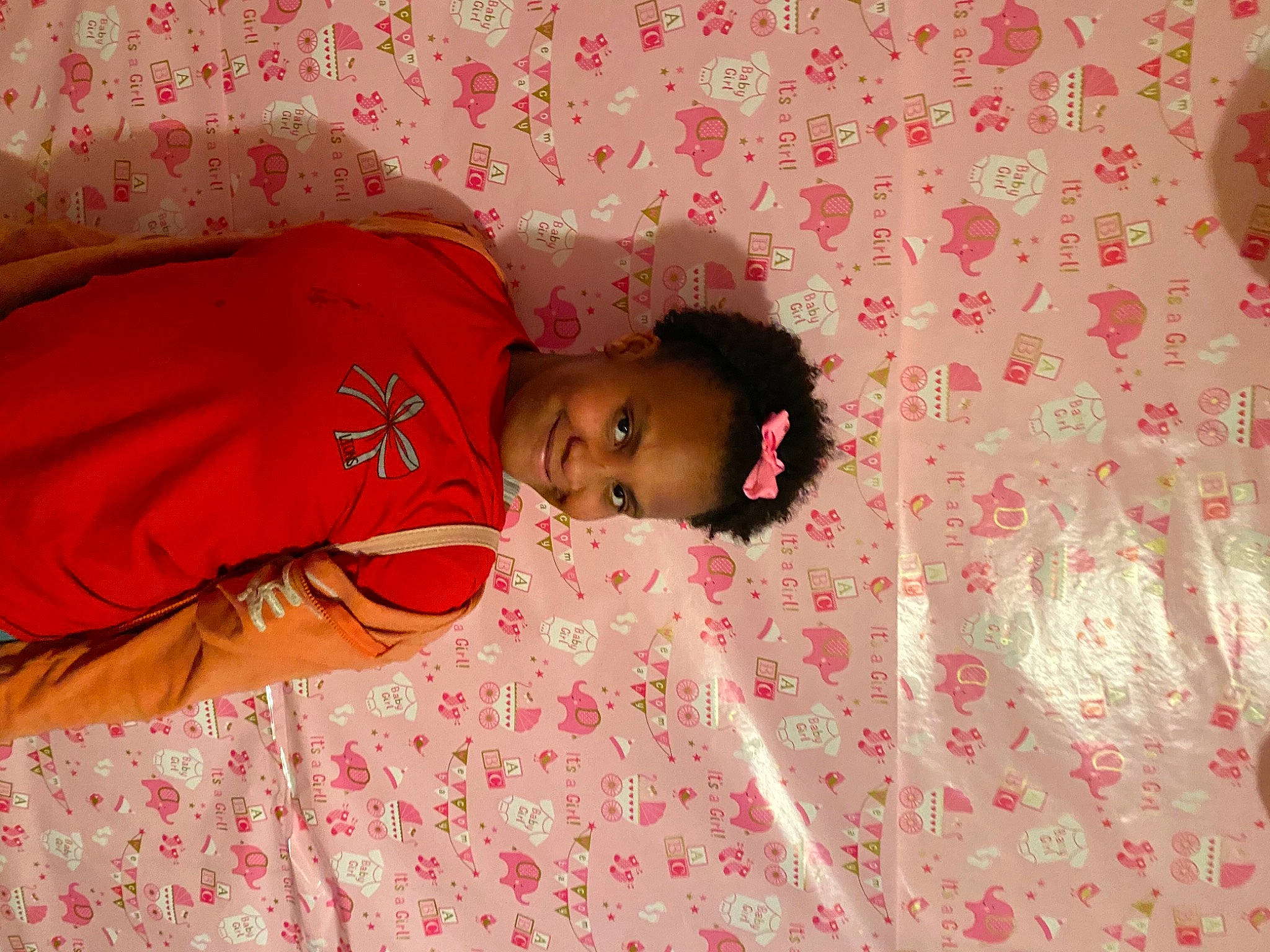Corteria is registered to the contest to win money with this photo: bedding, child, comfort, event, flesh, flooring, fun, happy, joy, linens, magenta, pattern, peach, person, pink, room, skin, sleeve, t_shirt, textile