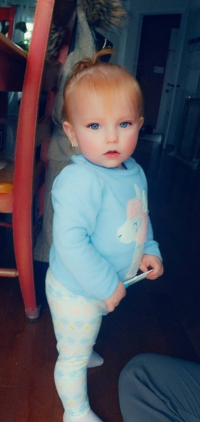 Kailey is registered to the contest to win money with this photo: baby, cheek, child, eye, face, head, iris, lip, outerwear, person, skin, sleeve, standing, toddler