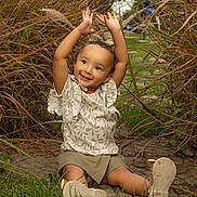 Aurora joined the competition — help win amazing prizes! toddler, child, smiling, happy, outdoor, grass, plants, nature, greenery, path, sitting, cute, arms_up, shorts, shirt, shoes, young_child, playful, sunlight, portrait