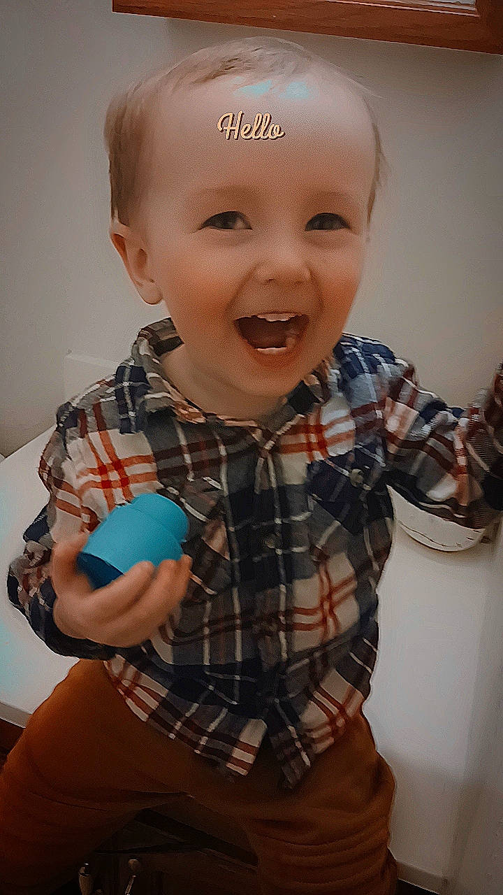 Stiles joined the competition — help win amazing prizes! cheek, chin, eye, facial_expression, finger, gesture, happy, human_body, mouth, nose, organ, person, plaid, product, skin, sleeve, smile, standing, tartan, thumb