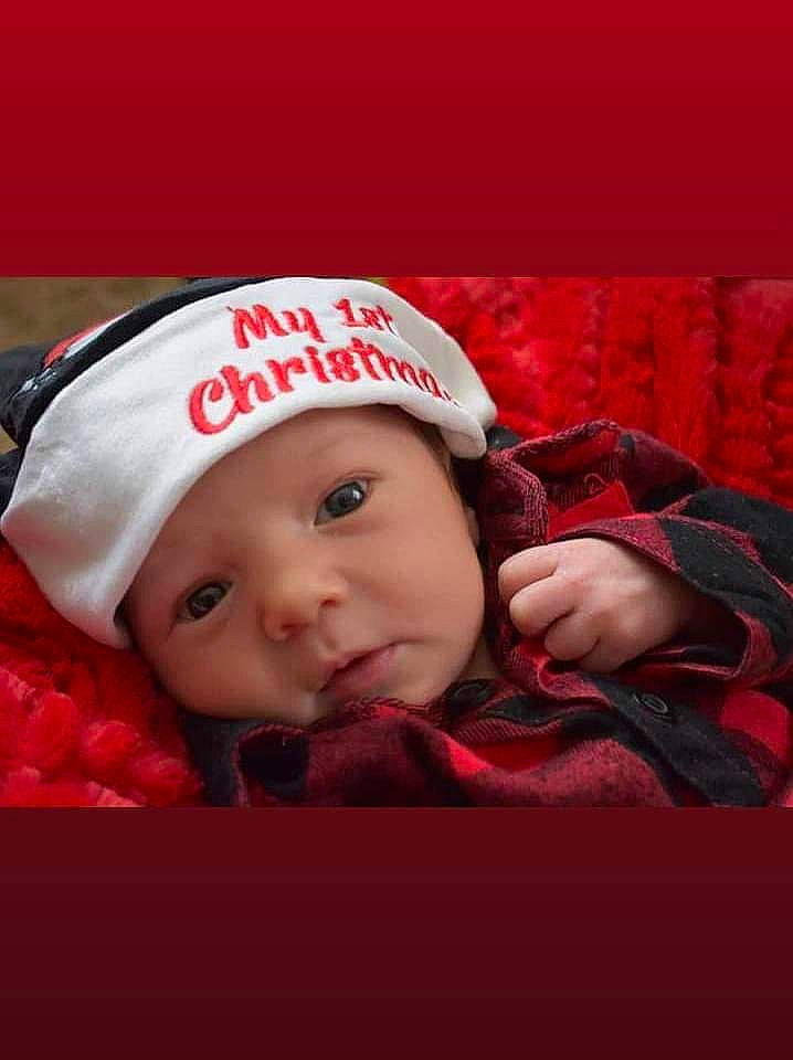 Stiles is registered to the contest to win money with this photo: baby, baby_products, baby_sleeping, baby_toddler_clothing, beanie, cap, carmine, christmas, comfort, event, flash_photography, fur, happy, headgear, headwear, holiday, knit_cap, lip, person, santa_claus
