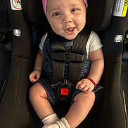 Evelynne joined the competition — help win amazing prizes! baby, child, car_seat, pink_bow, headband, denim_overalls, white_socks, smiling, happy, infant, safety_harness, seatbelt, cute, portrait, indoor, young_child, baby_clothes, hands, legs, face