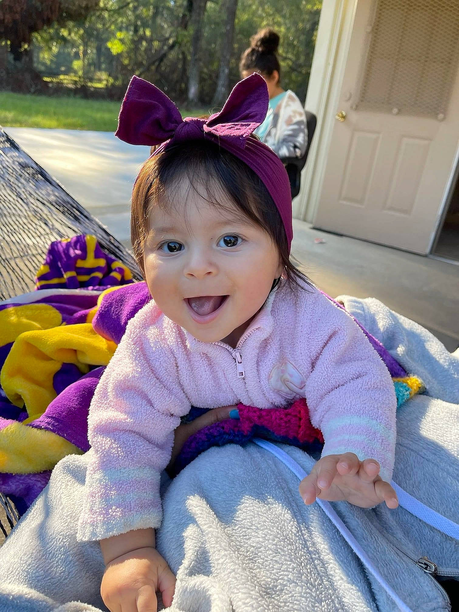 Analucia is registered to the contest to win money with this photo: baby_toddler_clothing, door, fun, grass, hair, happy, iris, leisure, magenta, person, pink, plant, product, purple, recreation, skin, smile, textile, toddler, tree