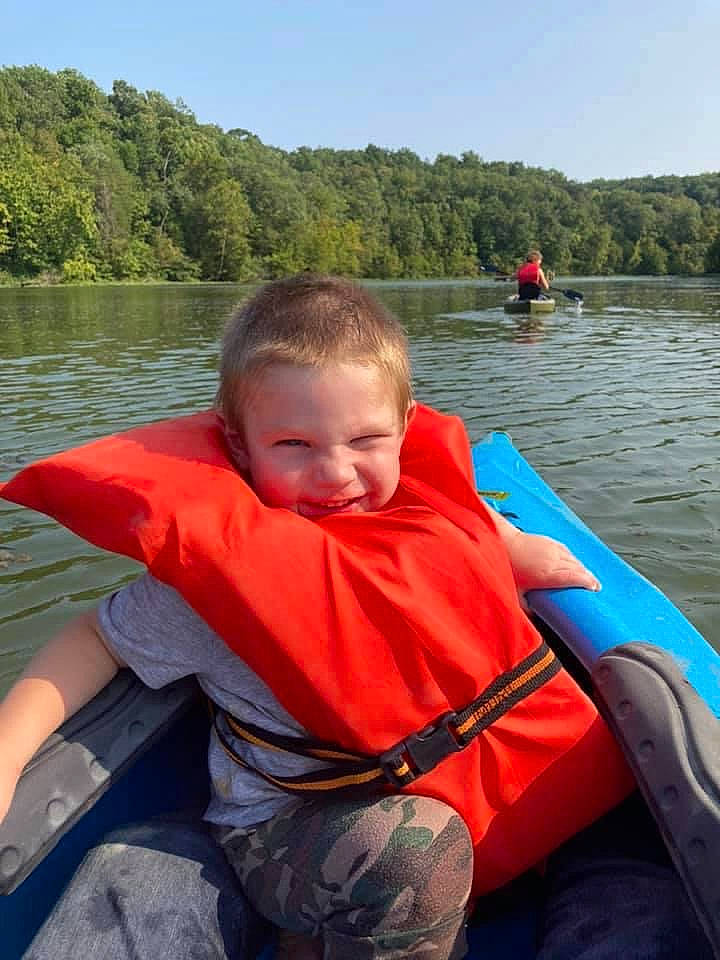 Corbyn is registered to the contest to win money with this photo: boat, boats_and_boating_equipment_and_supplies, body_of_water, fun, joy, lake, leisure, lifejacket, oar, outdoor_recreation, person, personal_protective_equipment, recreation, sky, smile, summer, tree, vehicle, water, water_transportation