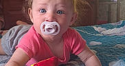 Serena joined the competition — help win amazing prizes! baby, pacifier, plush_toy, bedroom, quilt, blue_eyes, tousled_hair, infant, child, crawling, colorful, soft_light, toy, bed, furniture, curious, indoor, person, cute, casual