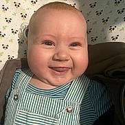 Leo participe au concours pour gagner de l'argent avec cette photo : baby, smiling, face, tongue, striped_clothing, overalls, pacifier, blanket, panda_pattern, cheeks, happy, infant, cute, child, portrait, indoors, clothing, closeup, mischievous, lying_down