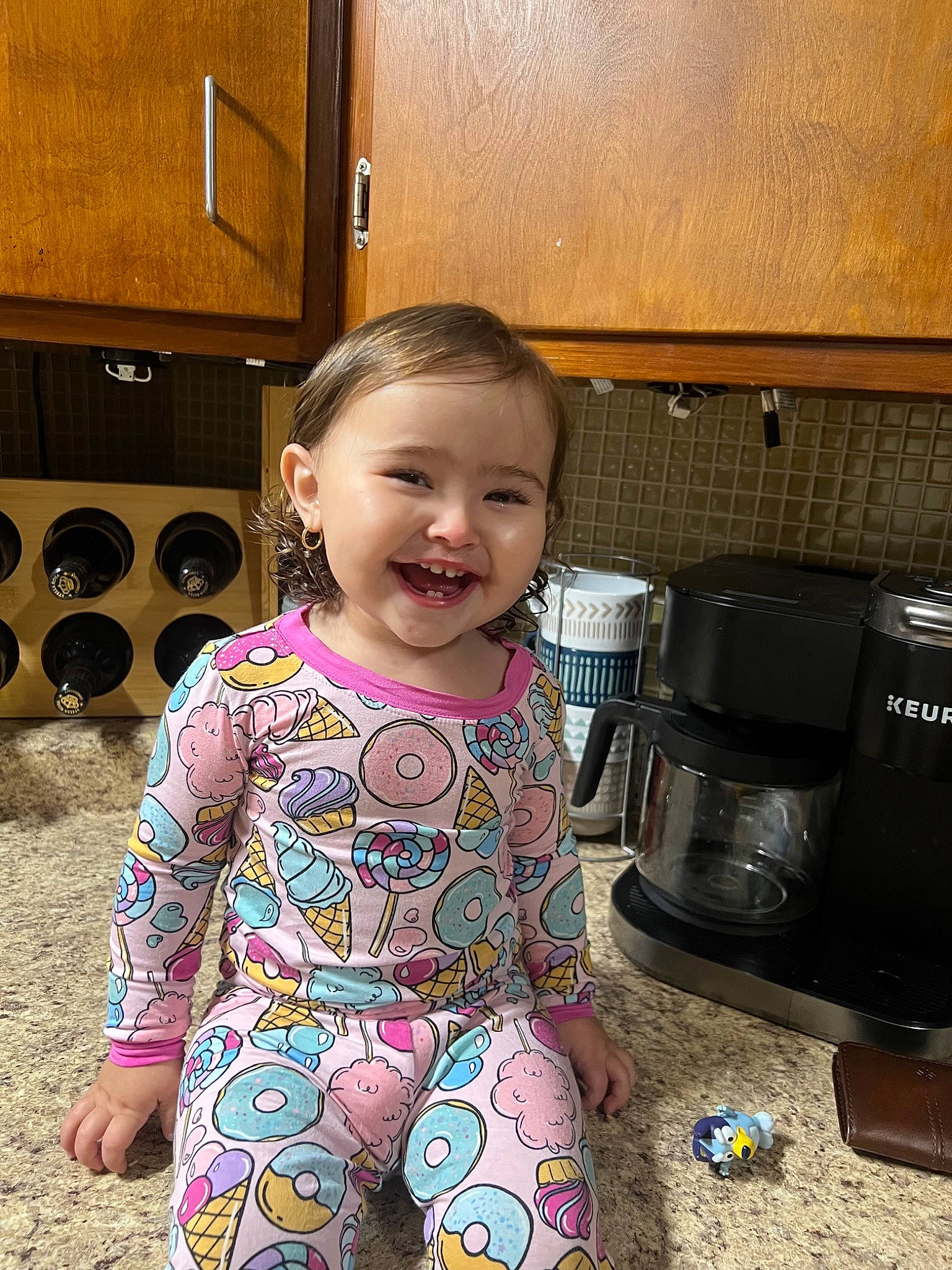 Ariyah is registered to the contest to win money with this photo: baby_toddler_clothing, child, cookware_and_bakeware, flooring, fun, happy, home_appliance, joy, kitchen, kitchen_appliance, person, play, room, sitting, sleeve, small_appliance, smile, soil, stove, toddler