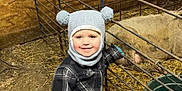Jase joined the competition — help win amazing prizes! animal, boy, cap, child, clothing, coat, face, footwear, hat, head, jacket, livestock, male, outdoors, pants, person, photography, portrait, sheep, shoe