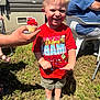 Jase joined the competition — help win amazing prizes! child, boy, birthday, cupcake, red_shirt, cars_theme, grass, outdoor, smiling, sunlight, shorts, shoes, hand, adult, chair, happy, celebration, food, party, person