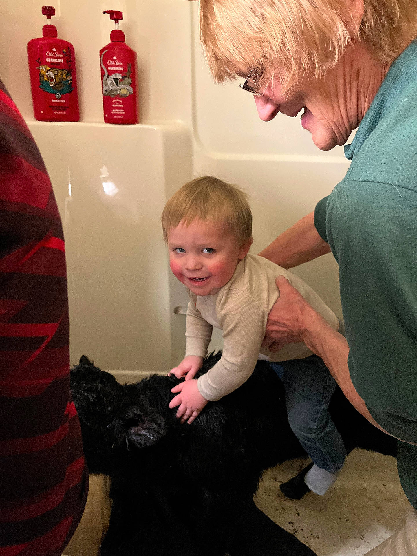 Jase is registered to the contest to win money with this photo: adult, animal, baby, bathing, bathtub, canine, clothing, couch, dog, face, furniture, head, male, man, pants, person, pet, photography, portrait, tub