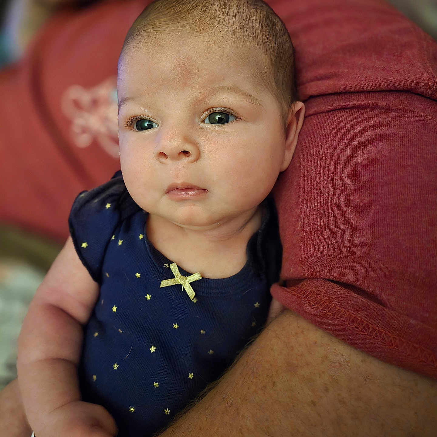 Novalee is registered to the contest to win money with this photo: applique, arm, baby, bodypart, couch, cushion, face, finger, frown, furniture, hand, head, homedecor, newborn, pattern, person, photography, portrait, sad, sitting