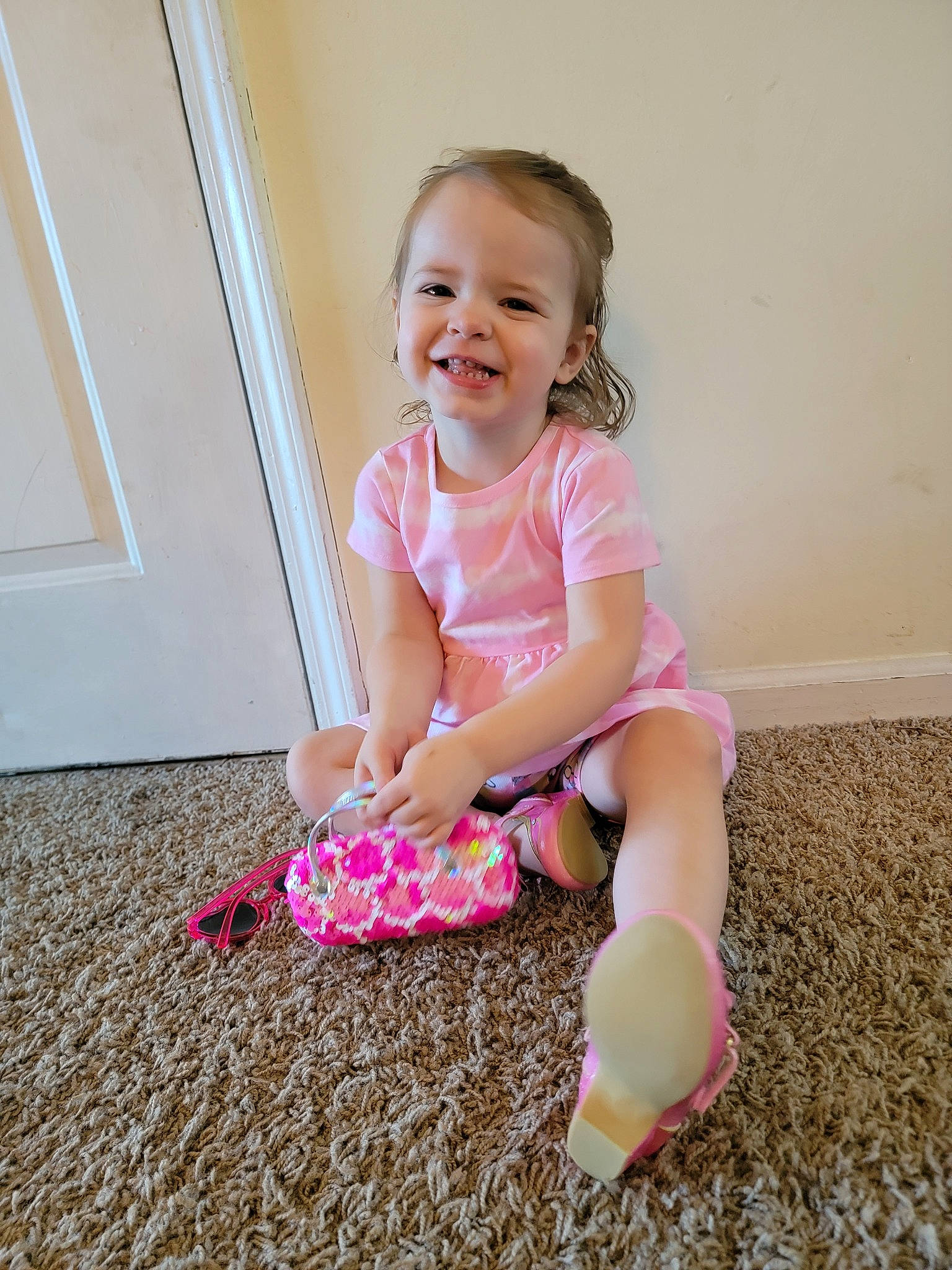Skyleigh is registered to the contest to win money with this photo: arm, baby_toddler_clothing, beauty, child, fun, happy, head, human_body, human_leg, joy, knee, magenta, people_in_nature, person, pink, sitting, sleeve, smile, sock, t_shirt