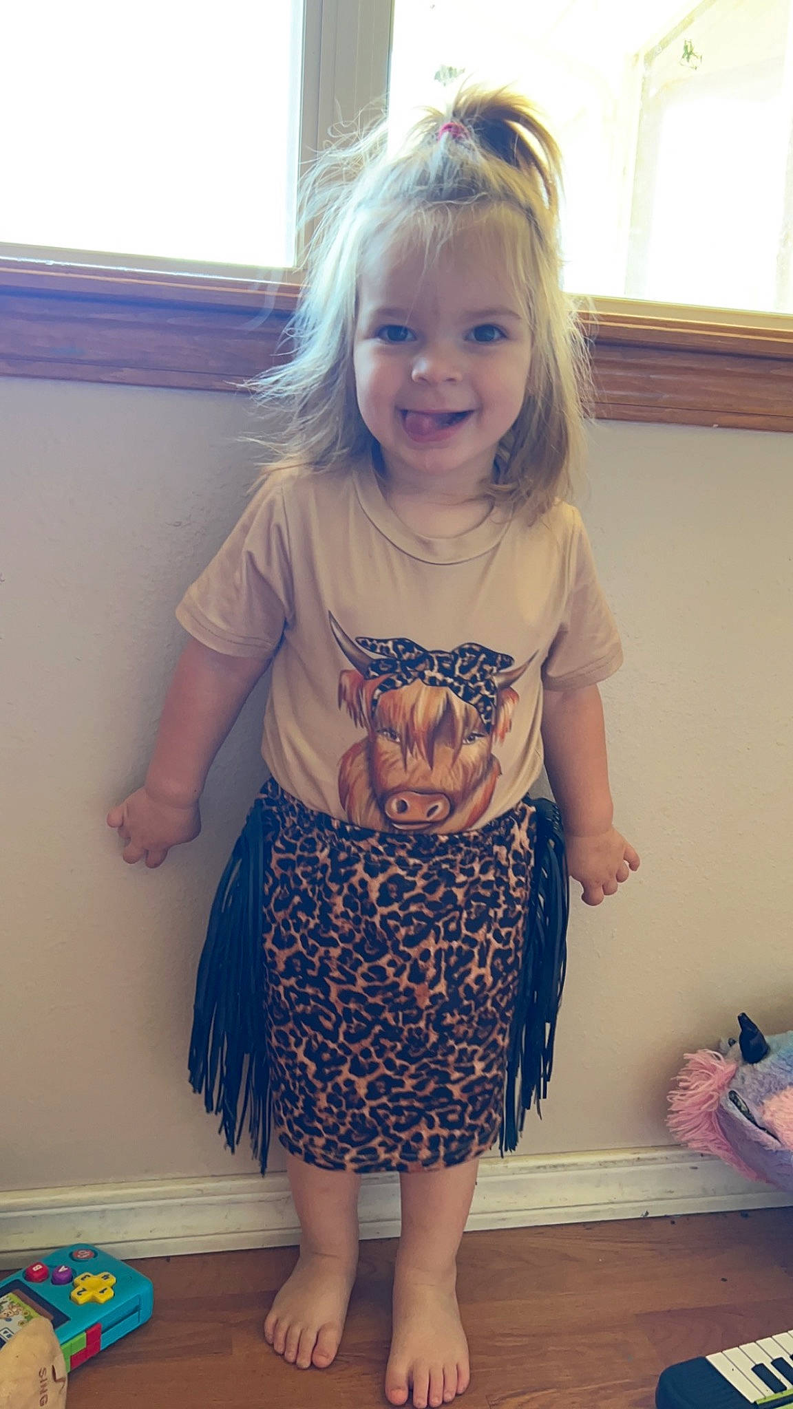 Makenna is registered to the contest to win money with this photo: baby_toddler_clothing, clothing, dress, face, hair, hairstyle, happy, head, iris, joint, joy, leg, person, shorts, shoulder, sleeve, smile, standing, t_shirt, thigh