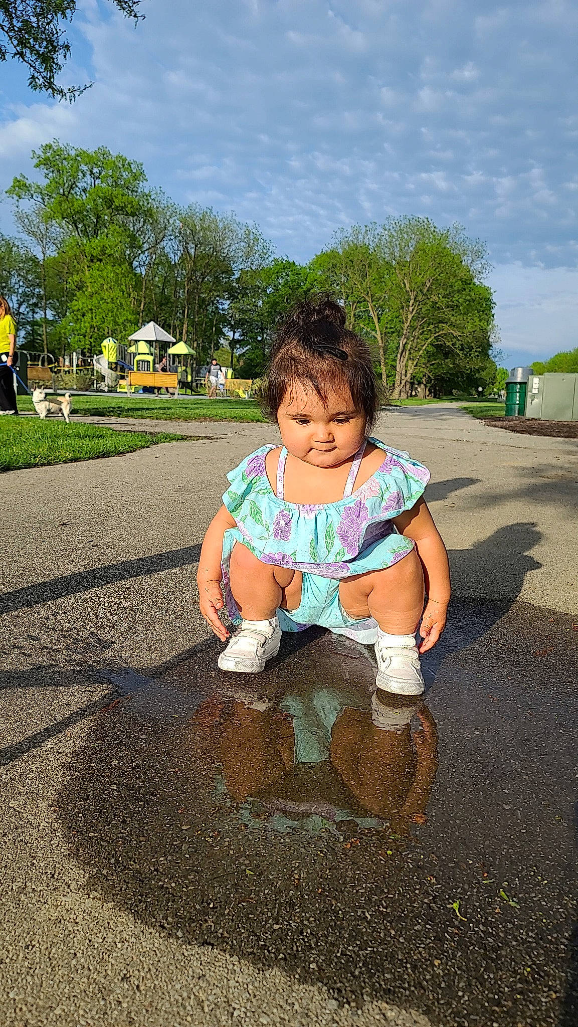 Estrella is registered to the contest to win money with this photo: asphalt, child, eye, fun, grass, happy, leisure, person, photography, plant, play, playground, public_space, sand, sitting, smile, soil, summer, toddler, tree