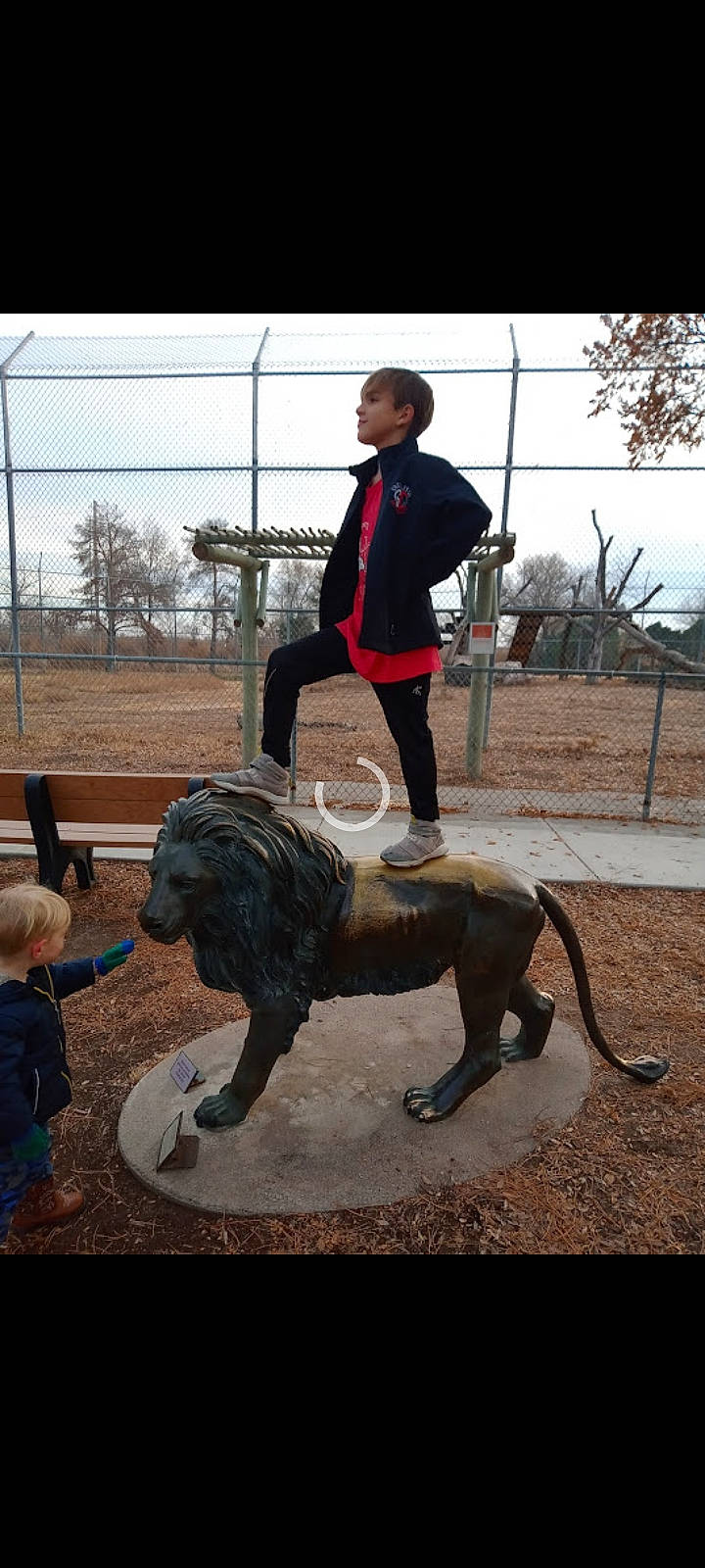 Bently is registered to the contest to win money with this photo: art, chainsaw_carving, dog_breed, fun, fur, grass, lawn_ornament, leisure, metal, monument, person, recreation, sculpture, sky, soil, sporting_group, statue, tail, terrestrial_animal, toddler