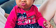 Ziyah is registered to the contest to win money with this photo: baby, bodypart, clothing, couch, cream, cushion, dessert, face, finger, furniture, hand, head, homedecor, indoors, pants, person, photography, portrait, sitting, t_shirt