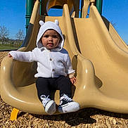 Ziyah is registered to the contest to win money with this photo: baby, cap, clothing, coat, face, footwear, grass, hat, head, jacket, outdoorplayarea, outdoors, person, photography, playarea, portrait, shoe, slide, sliding, toy